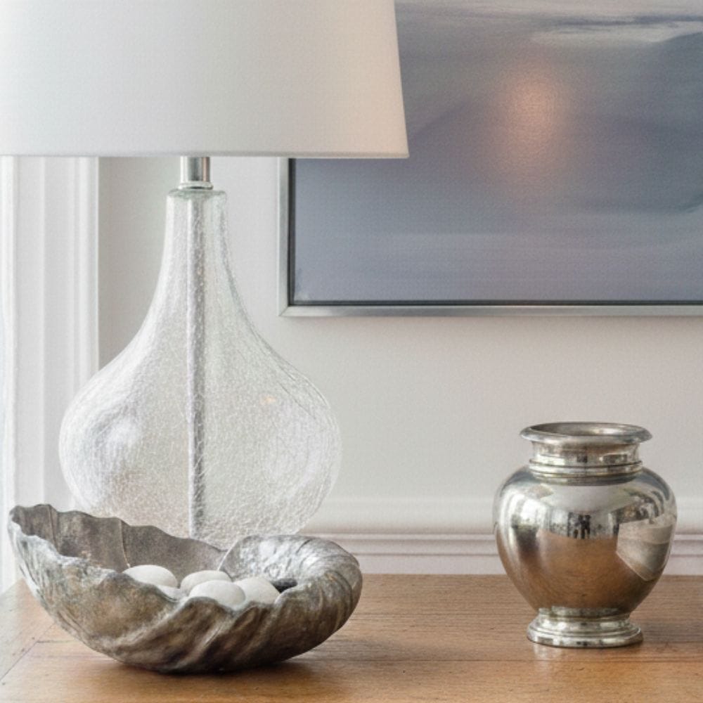 Mixing modern chrome fixtures with antique silver home decor for a curated tabletop.